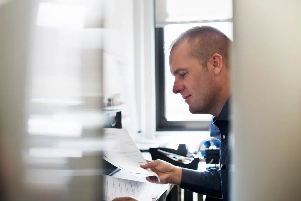 a man working in an office reading paperwork 2026 01 09 08 42 11 utc